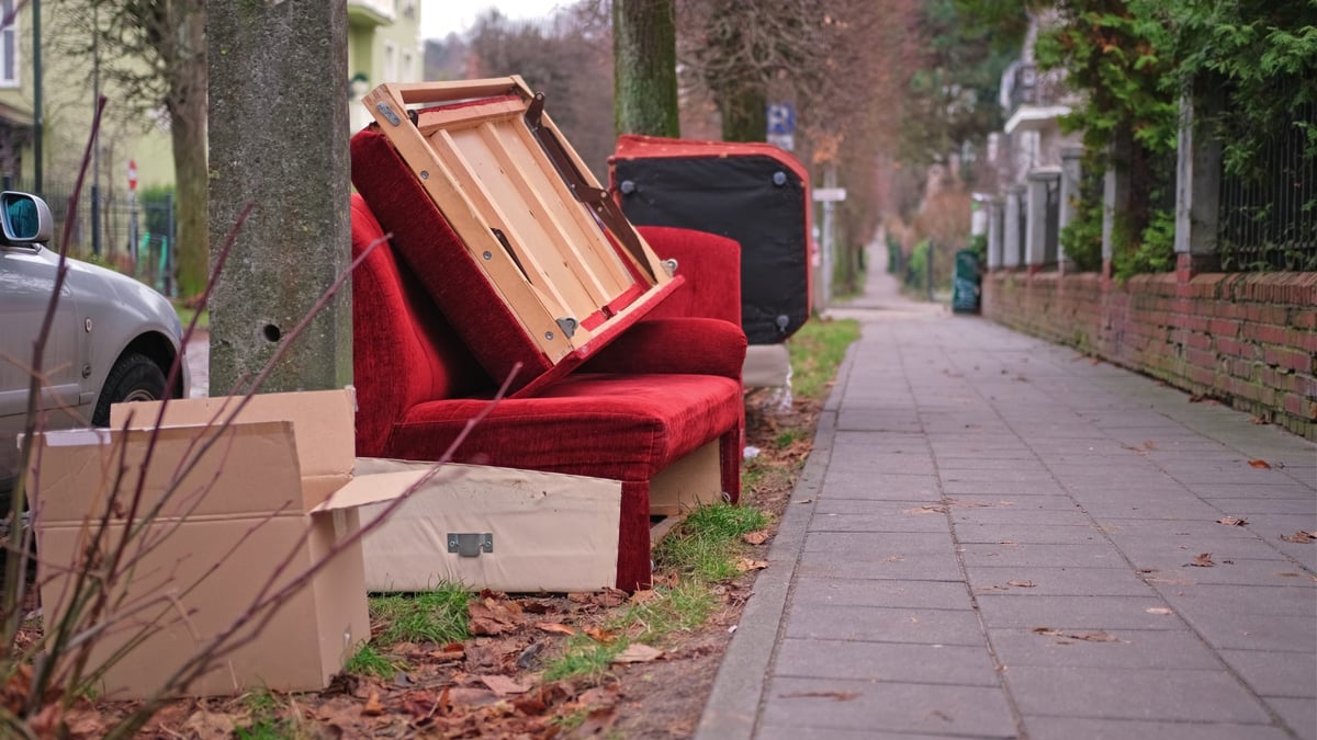 Old Unwanted Furniture Couch Dumped on Sidewalk on Bulk Garbage Collection Day for Curbside Pickup