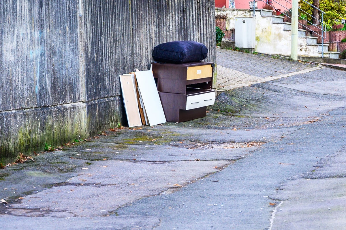 Discarded furniture and mattress left on the sidewalk